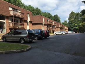 Collinsville apartment for rent - A street view of apartment buildings with cars parked in front.