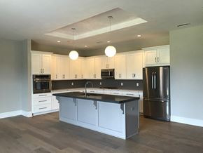 Williamsville apartment for rent - a kitchen with white cabinets and a black counter top