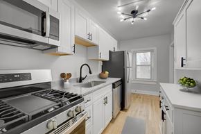 Denver apartment for rent - a kitchen with white cabinets and stainless steel appliances