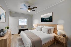 Denver apartment for rent - a bedroom with a large bed and a ceiling fan