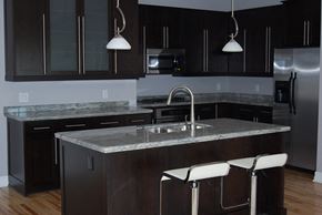 East Amherst apartment for rent - a kitchen with a marble counter top and black cabinets