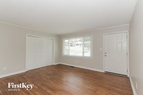 Gastonia house for rent - the living room of a home with a wooden floor and white doors
