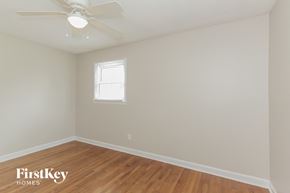 Gastonia house for rent - the bedroom with hardwood flooring and a ceiling fan