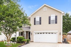 Winston-Salem house for rent - a yellow house with a white garage door