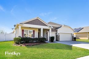 Haines City house for rent - a house with a driveway and lawn in front of it