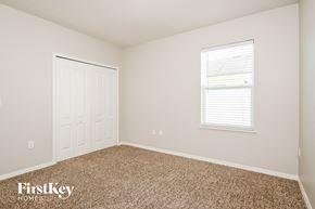 Haines City house for rent - a bedroom with carpet and a white door and window