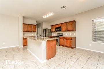 Princeton house for rent - a kitchen with wooden cabinets and a granite counter top