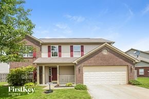 Greenfield house for rent - a brick house with a white garage door