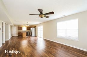Greenfield house for rent - an empty living room with a ceiling fan and a kitchen