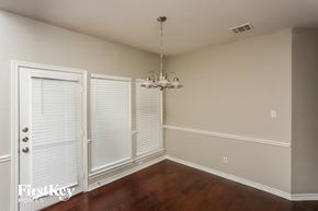 Fort Worth house for rent - a dining room with a chandelier and a door to a closet