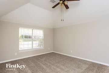 Fort Worth house for rent - the living room of a home with carpet and a ceiling fan