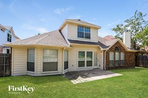 Fort Worth house for rent - the front of a yellow house with a yard and grass