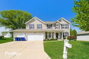 Lake Saint Louis house for rent - a suburban house with a driveway and a white garage door