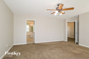 Lake Saint Louis house for rent - a living room with a ceiling fan and a carpet