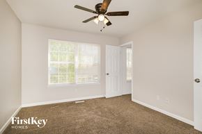 Lake Saint Louis house for rent - a bedroom with carpet and a ceiling fan