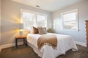 Salt Lake City house for rent - a bedroom with a bed and two windows