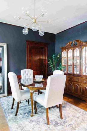 Salt Lake City apartment for rent - a dining room with blue walls and a wooden table with white chairs