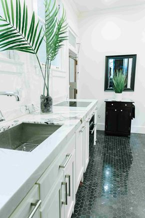 Salt Lake City apartment for rent - a large white kitchen with a sink and a counter top