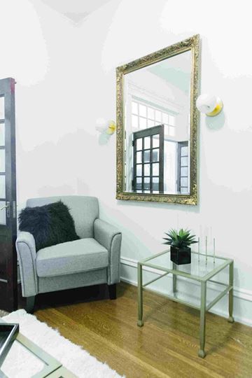 Salt Lake City apartment for rent - a small living room with a couch and a mirror