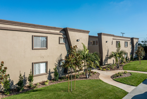 Westminster apartment for rent - a group of apartments with a walkway and grass and trees