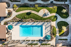 Westminster apartment for rent - an aerial view of a swimming pool in a backyard with a lawn and a lawn