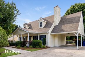 Winston-Salem house for rent - A house with a white exterior and a brown roof is shown.