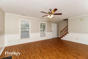 Winston-Salem house for rent - A room with wooden floors and a ceiling fan.