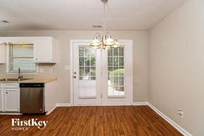 Winston-Salem house for rent - A kitchen with a sink, dishwasher, and a chandelier.
