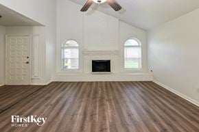 Humble house for rent - the living room of an empty house with a fireplace