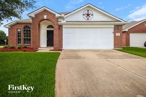 Houston house for rent - a house with a driveway and a white garage door