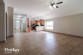Houston house for rent - an empty living room with tile flooring and a ceiling fan