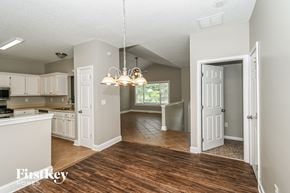 Temple house for rent - a kitchen and dining room with white cabinets and a wood floor