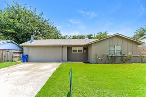 Burleson house for rent - A house with a garage and a green lawn.