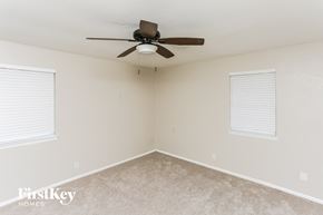 Burleson house for rent - A room with a ceiling fan and two windows.