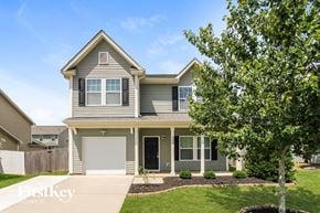 Landis house for rent - a gray house with a white garage door and a tree