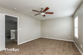 Landis house for rent - a bedroom with a ceiling fan and carpeting