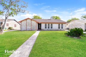 Houston house for rent - A brick house with a tree in front of it.