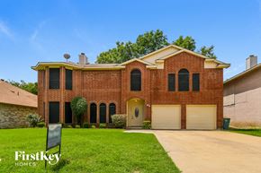 Cedar Hill house for rent - a large brick house with a driveway and a garage door