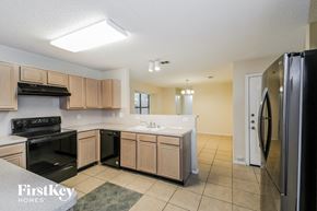 Cedar Hill house for rent - a kitchen with black appliances and wooden cabinets