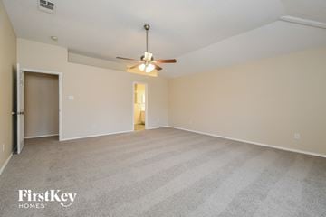 Cedar Hill house for rent - a spacious living room with carpet and a ceiling fan