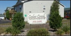 Rothschild apartment for rent - a cedar creek apartments sign in front of a house