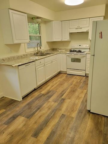 Weston apartment for rent - A kitchen with white cabinets and a wooden floor.