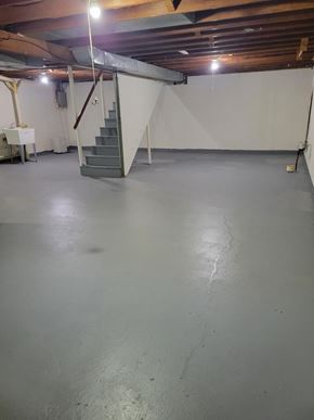 Weston apartment for rent - A spacious basement with a concrete floor and a staircase leading to the upper level.