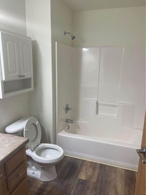 Kronenwetter apartment for rent - A white toilet sits in a bathroom next to a walk-in shower.
