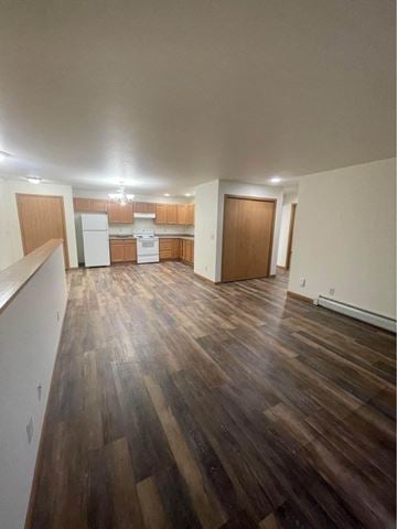 Kronenwetter apartment for rent - A kitchen with wooden floors and white appliances.