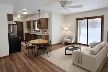 Wausau apartment for rent - A modern living room with a dining table and chairs.
