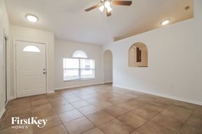 Orlando house for rent - A spacious room with a ceiling fan and a door leading to a balcony.