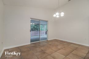 Orlando house for rent - A room with a sliding glass door and tiled floor.