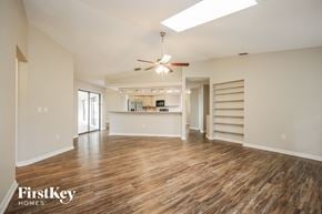 Punta Gorda house for rent - an empty living room with wood flooring and a ceiling fan