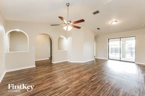 Punta Gorda house for rent - an empty living room with hardwood floors and a ceiling fan